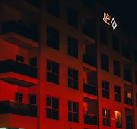 Evening exterior view of Dreamstage Media Group’s building glowing with red and black lights against the Kathmandu skyline.
