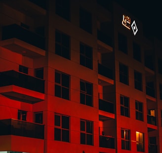 Evening exterior view of Dreamstage Media Group’s building glowing with red and black lights against the Kathmandu skyline.