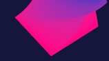 A digital abstract design featuring overlapping translucent shapes in shades of pink and purple. The background is a dark blue, allowing the vibrant colors of the shapes to stand out.