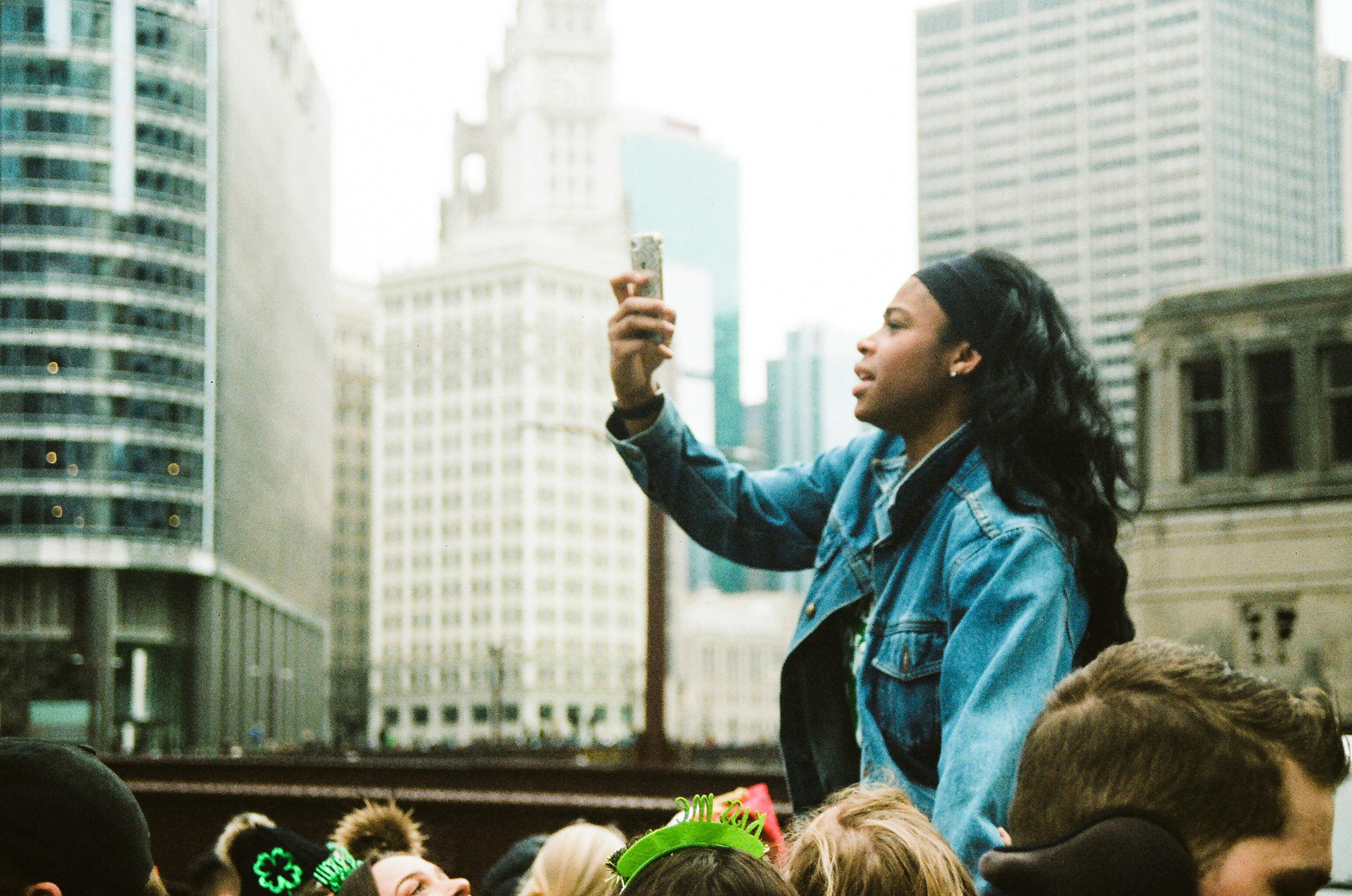 a woman taking a picture of a crowd of people
