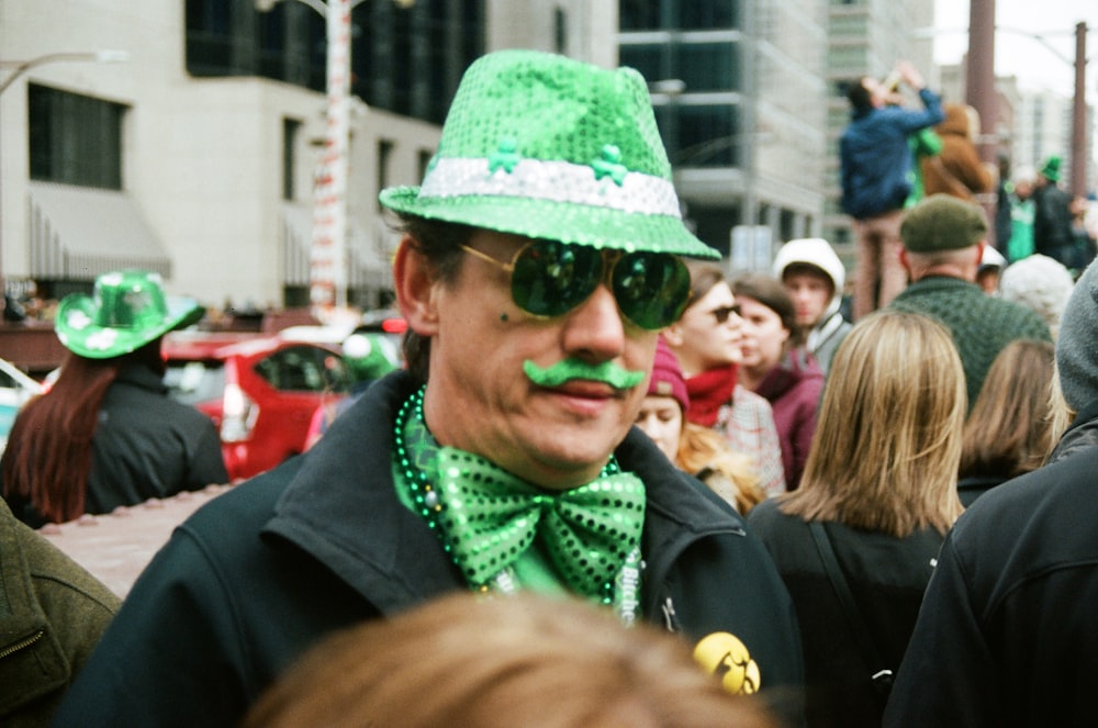 a man wearing a green hat and a green bow tie