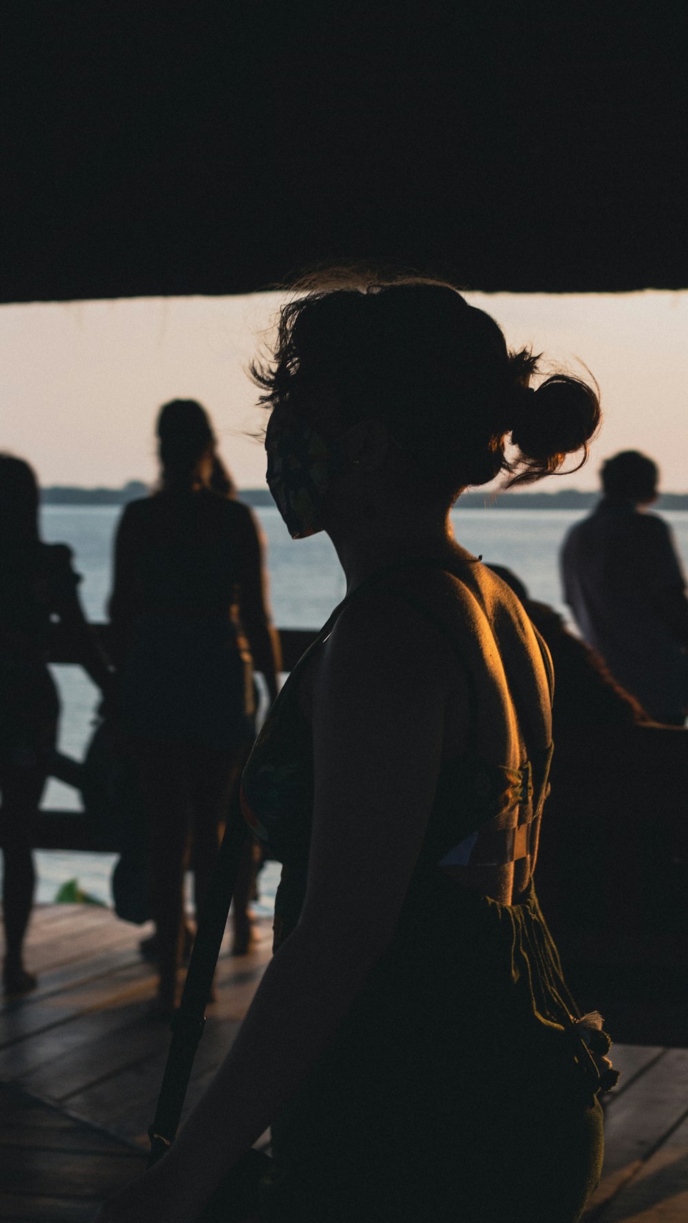 a group of people standing on top of a pier