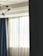 A bright living room featuring elegant pleated curtains softly filtering sunlight.