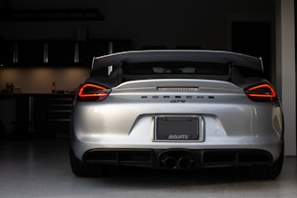 A sleek Porsche 911 GT3 parked on the Nürburgring pit lane under soft morning light.