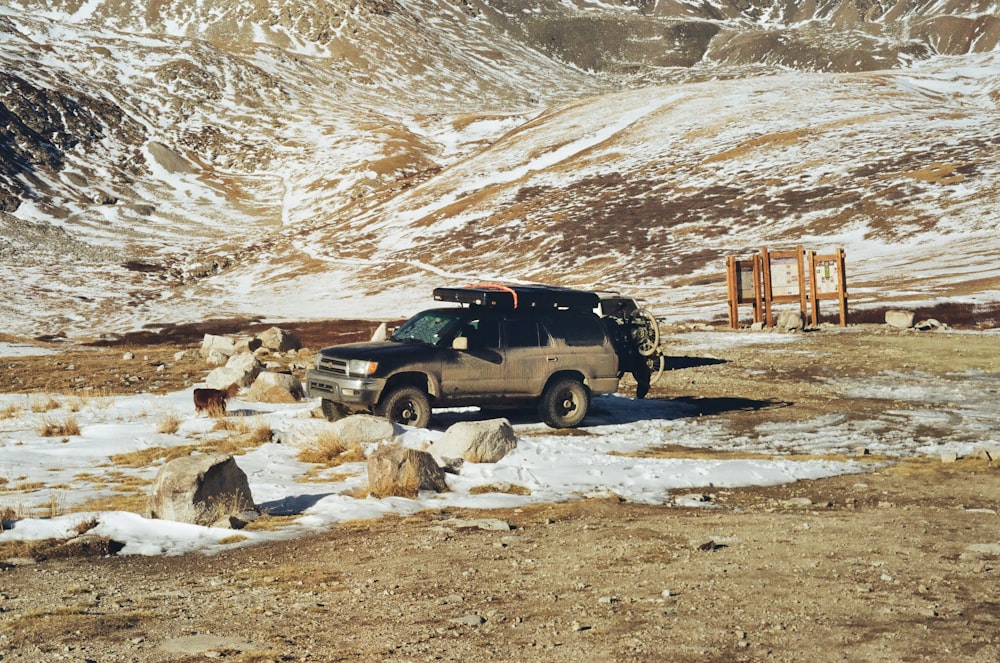 a pick up truck parked in a snowy field