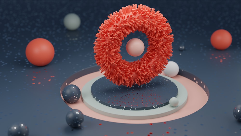 a red object is surrounded by balls and spheres