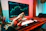a person holding a coin in front of a computer