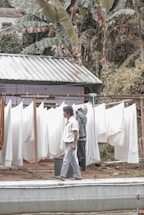 A friendly staff member picking up laundry from a tropical Ubud home.