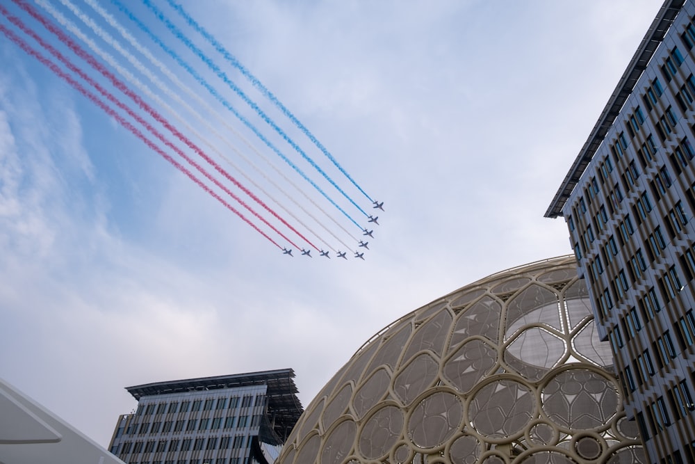 a group of airplanes flying over a building