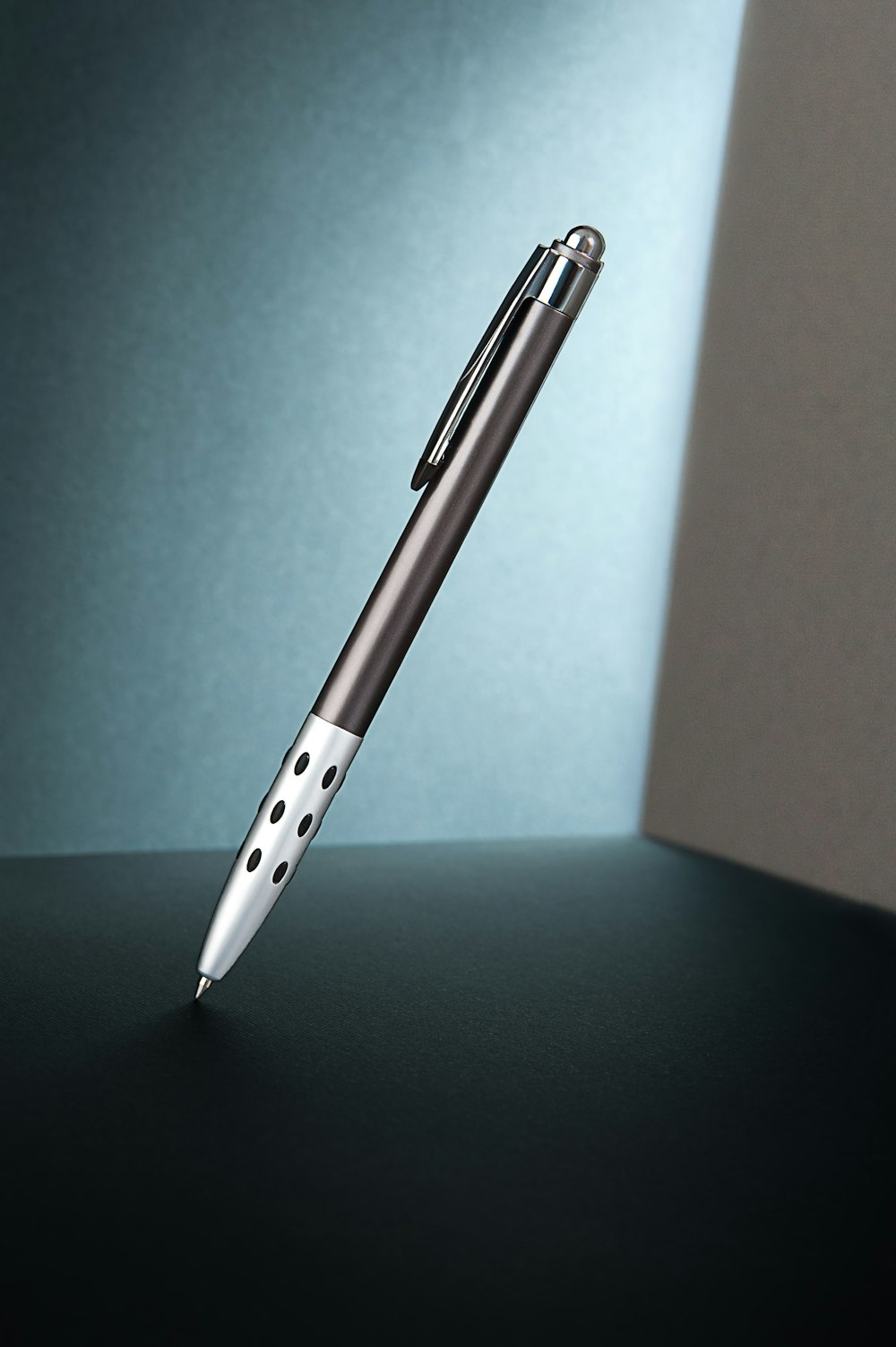 a pen sitting on top of a black table
