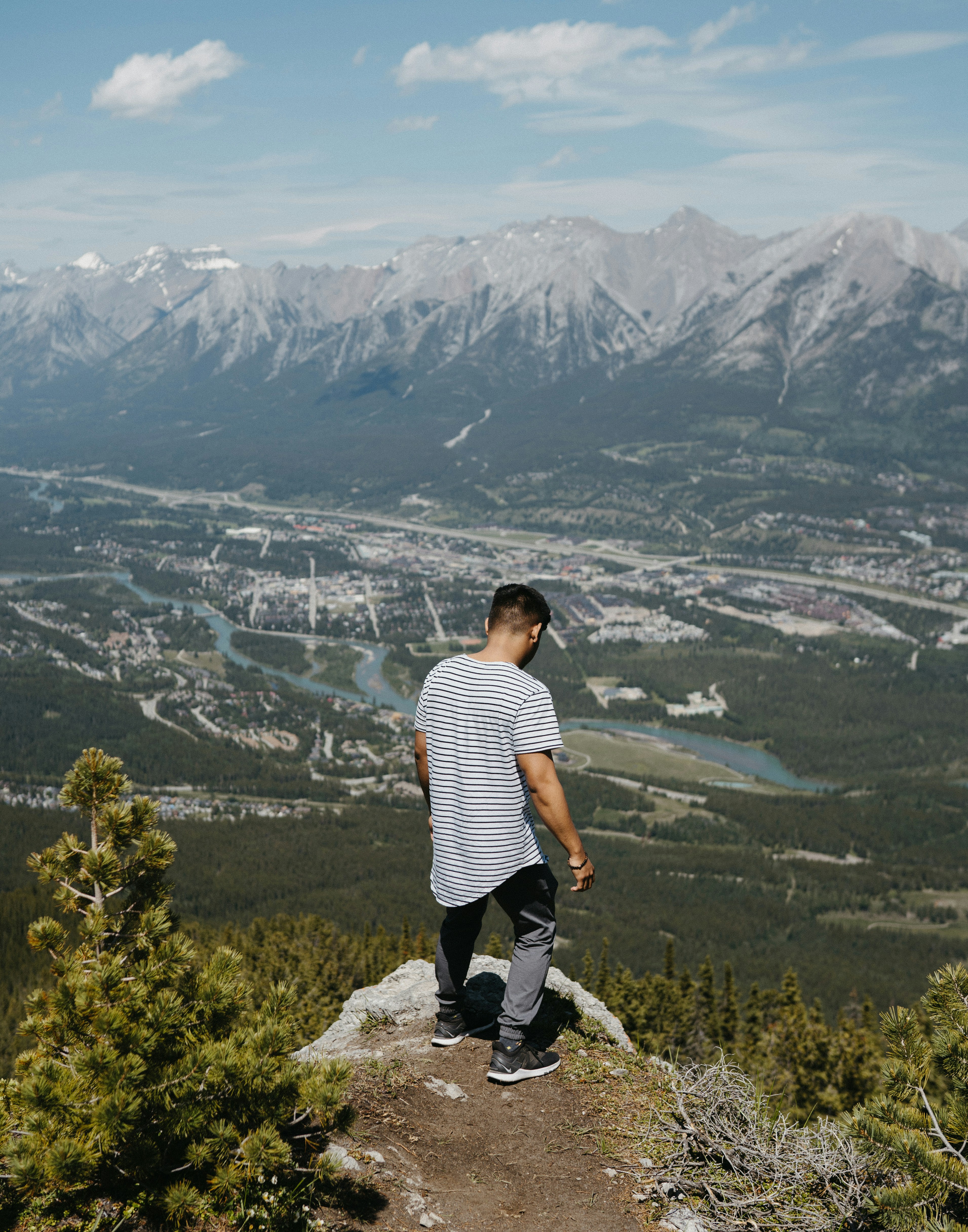 a man standing on top of a mountain overlooking a valley