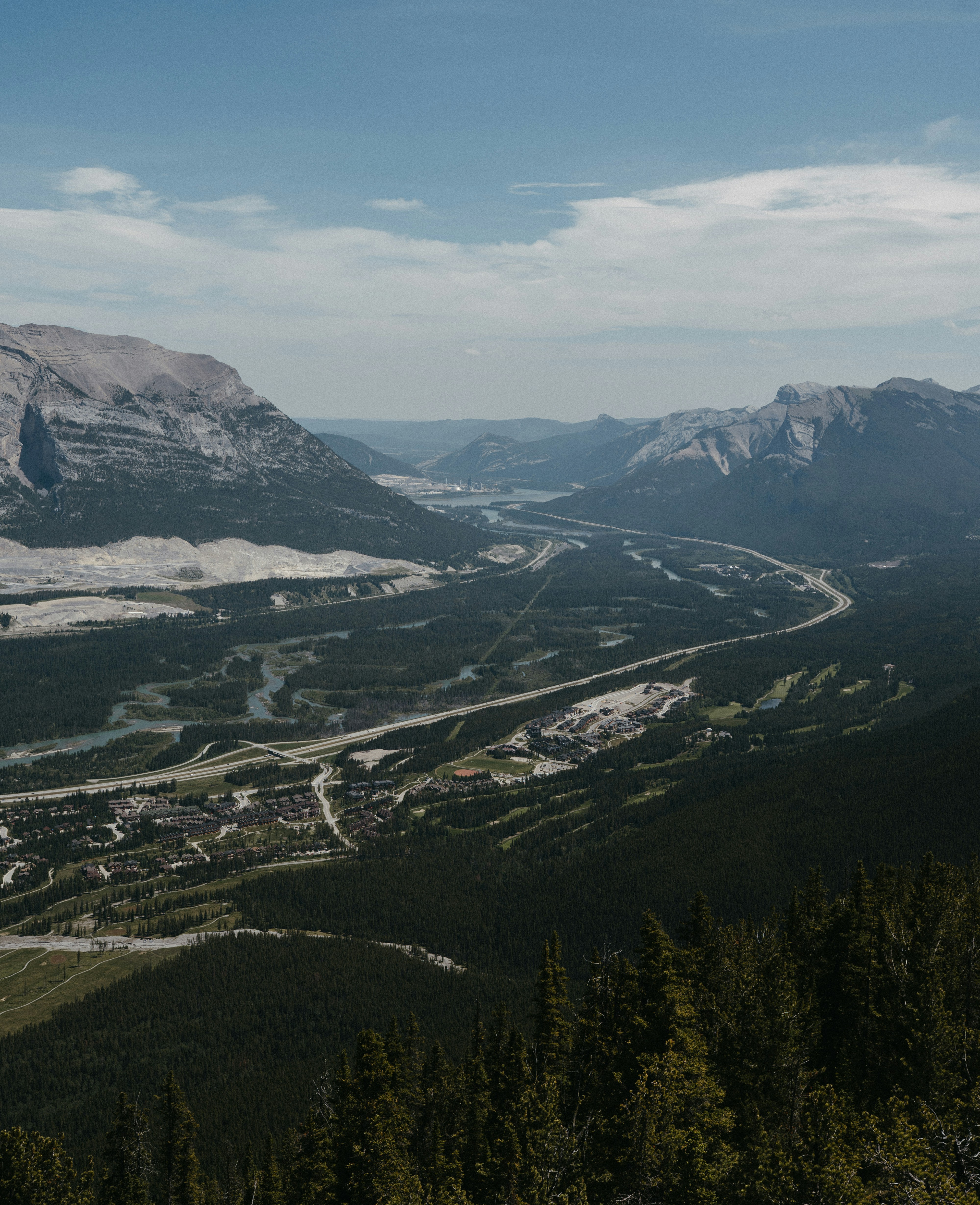 a view of a valley and mountains from the top of a mountain