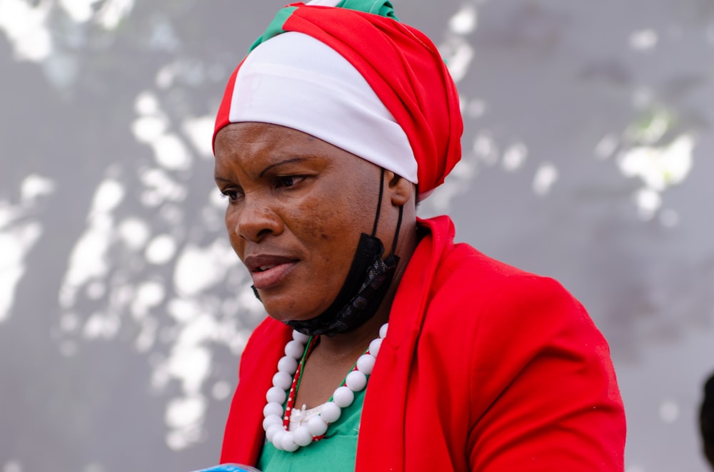 a woman wearing a red jacket and a green shirt