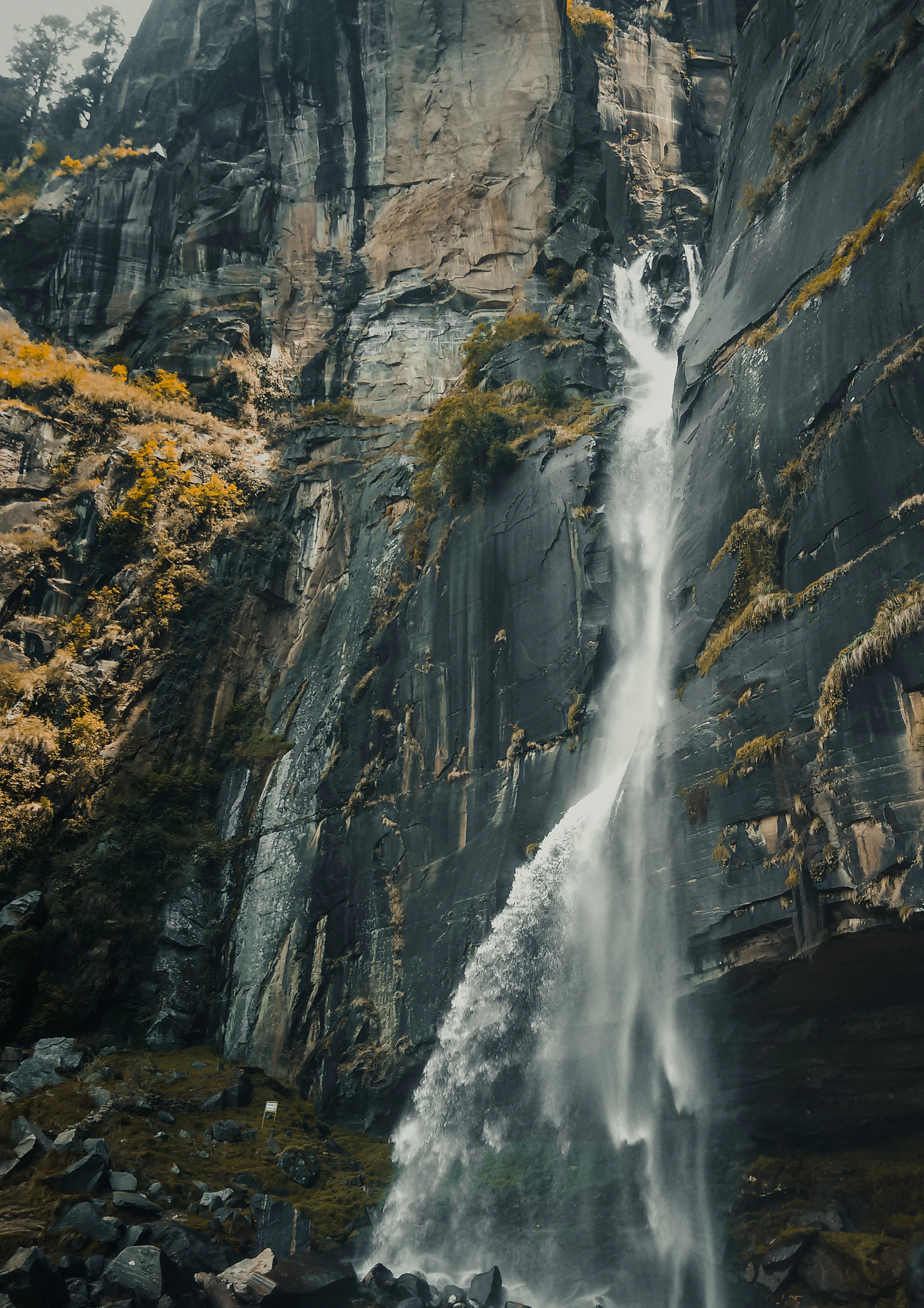 Jogini Waterfall cascading down a tall rock face near Manali, Himachal Pradesh