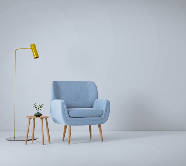 a blue chair and a yellow lamp in a white room