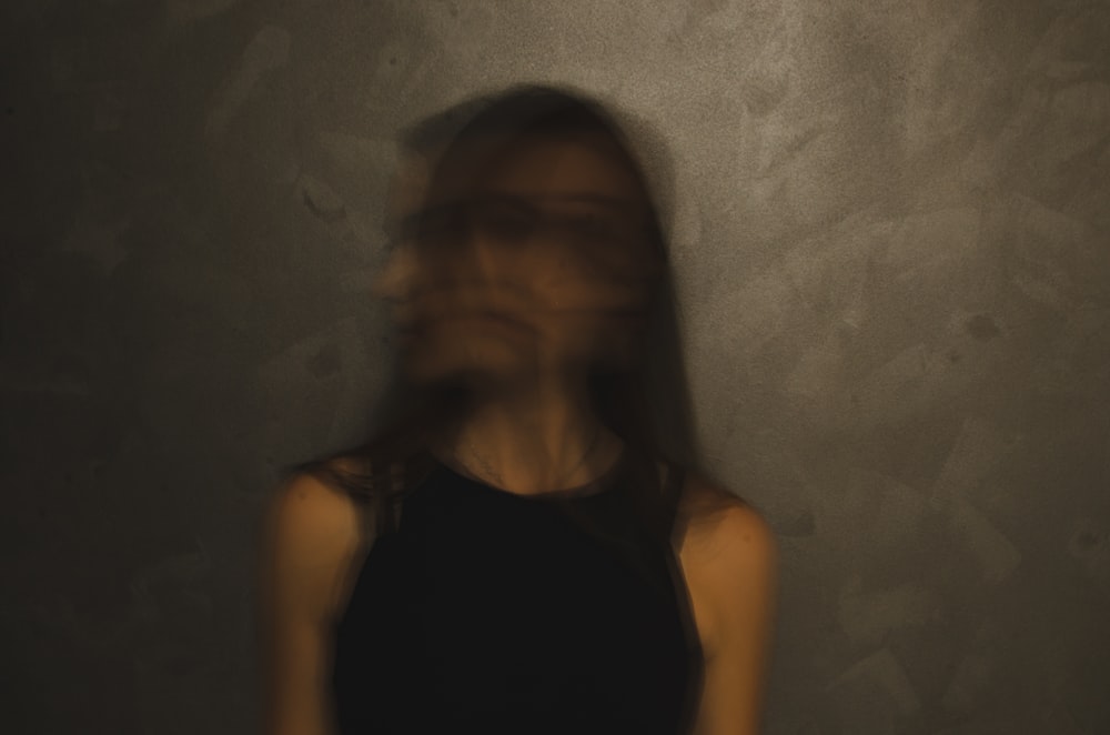 a blurry photo of a woman in a black top