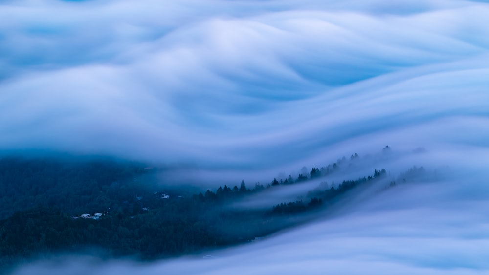 a view of a mountain covered in clouds