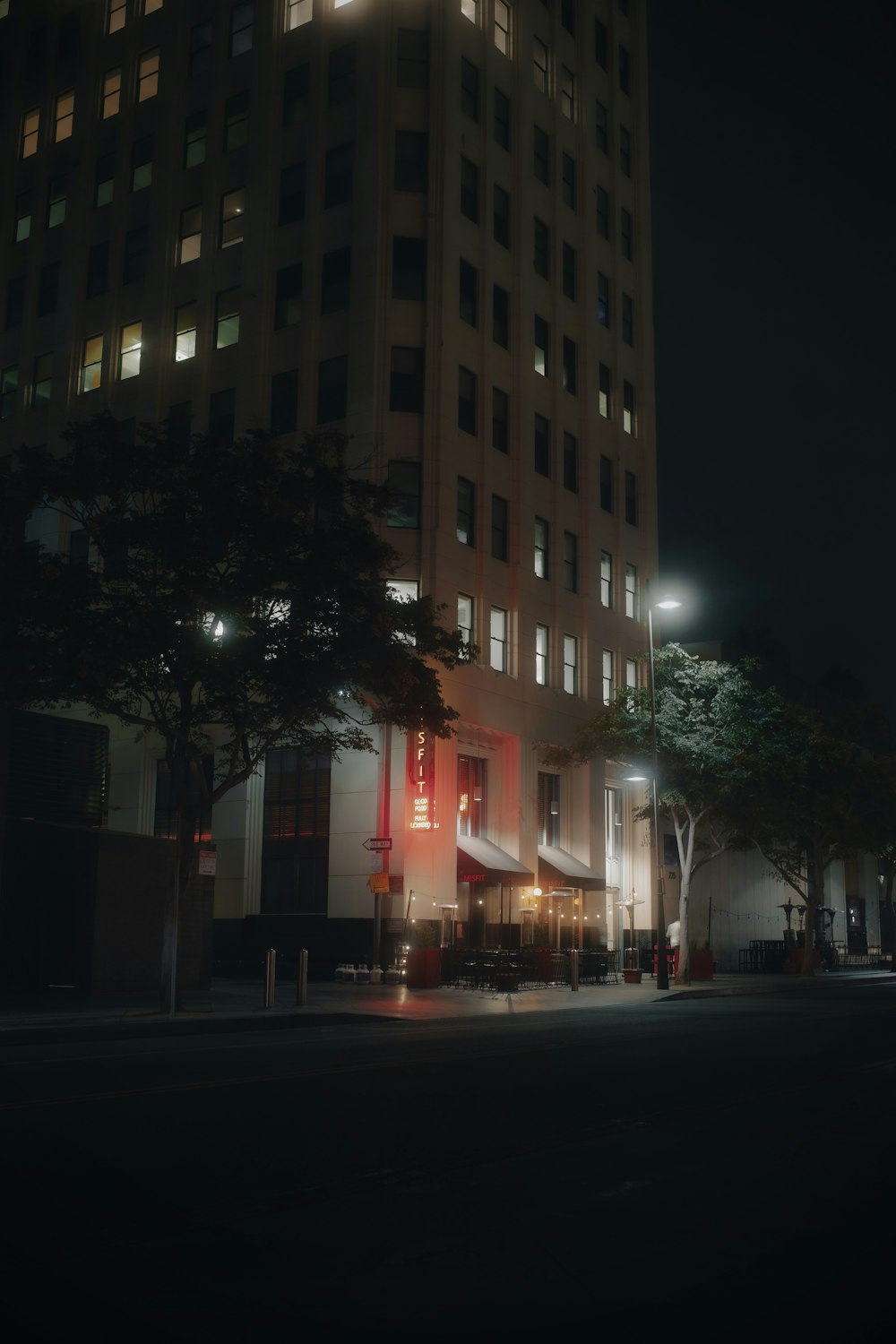 a tall building sitting next to a street at night