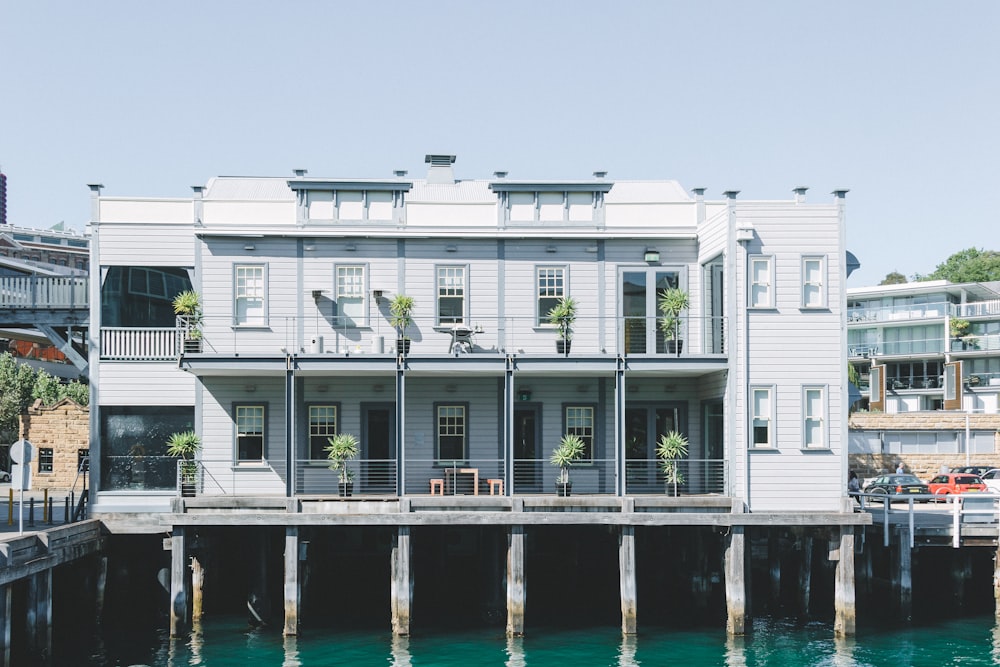 a large white building sitting next to a body of water