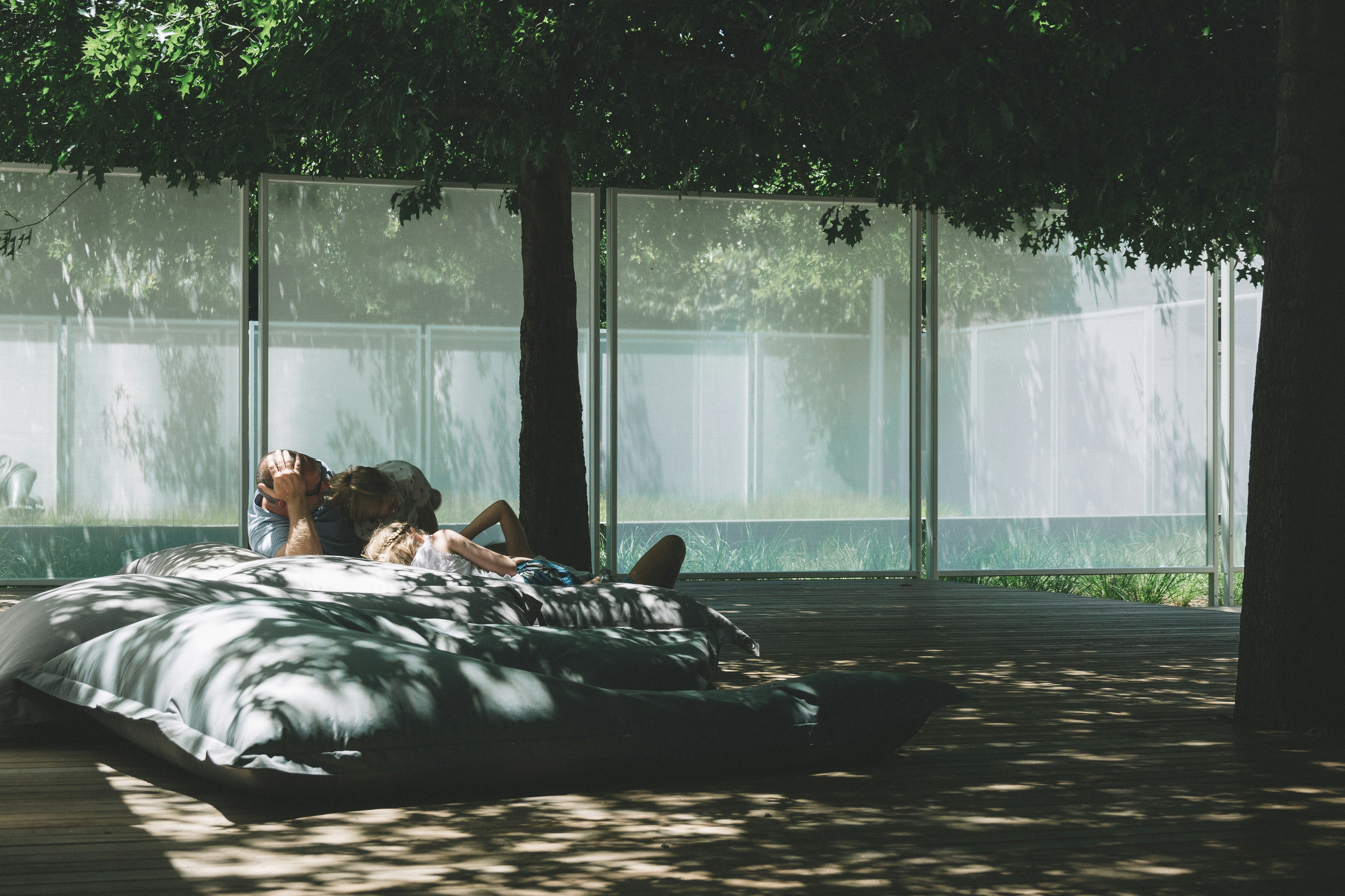a couple of people sitting on top of a bean bag