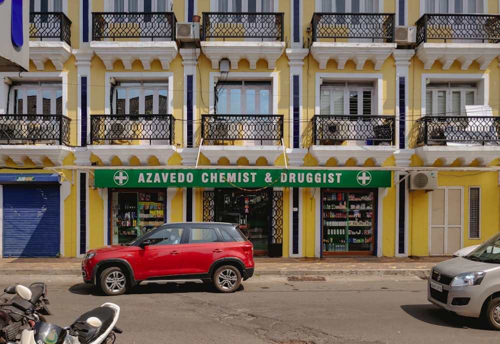 a red car parked in front of a building