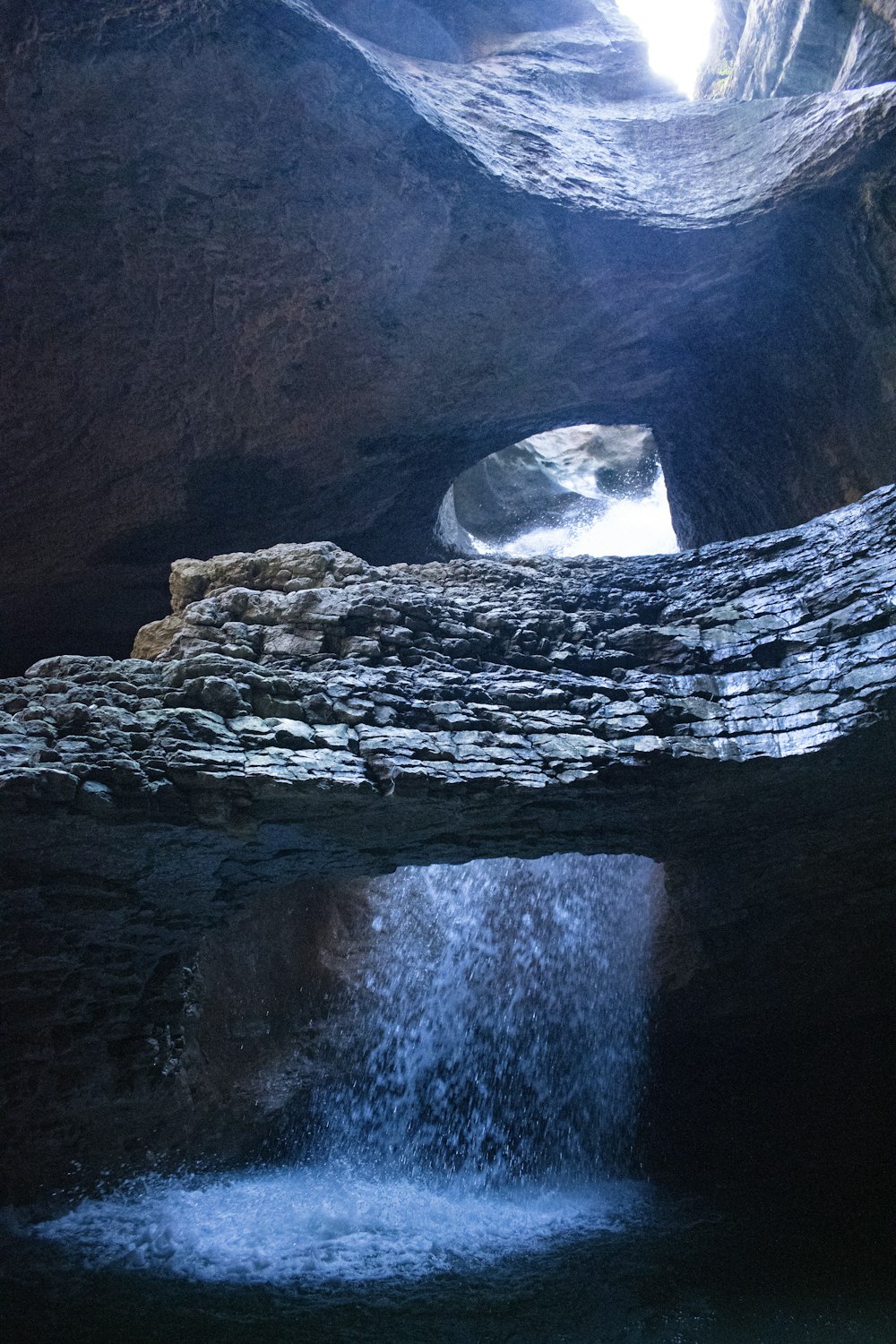 a cave with a waterfall coming out of it