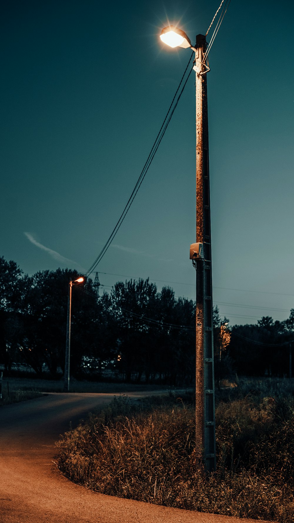 a street light sitting on the side of a road