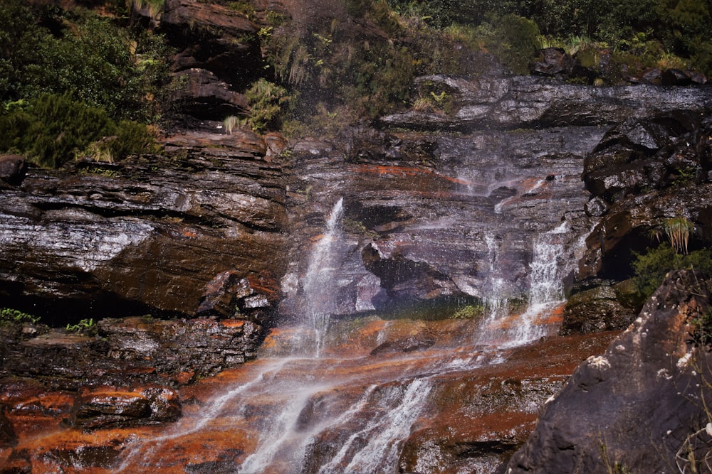 a waterfall with red water running down it