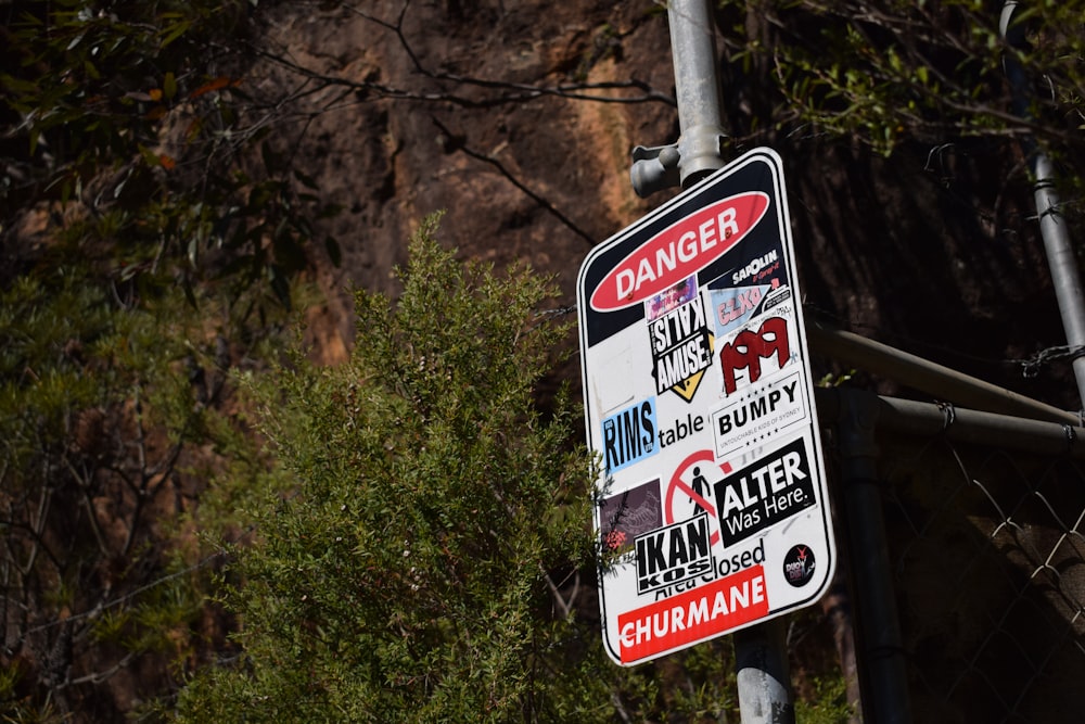 a close up of a street sign with trees in the background