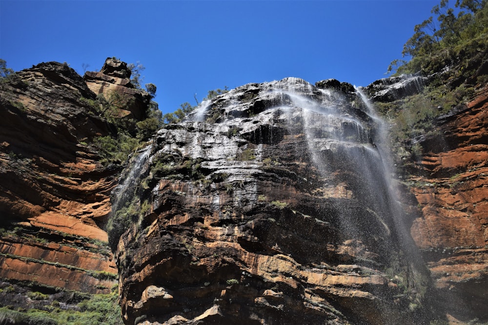 a large waterfall cascading over a rocky cliff