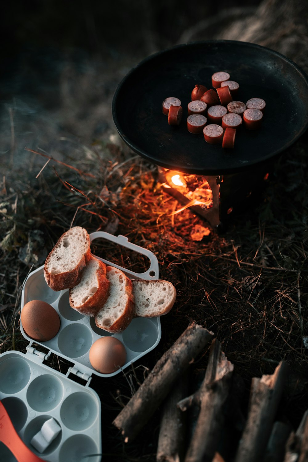 a grill with eggs and sausages next to it
