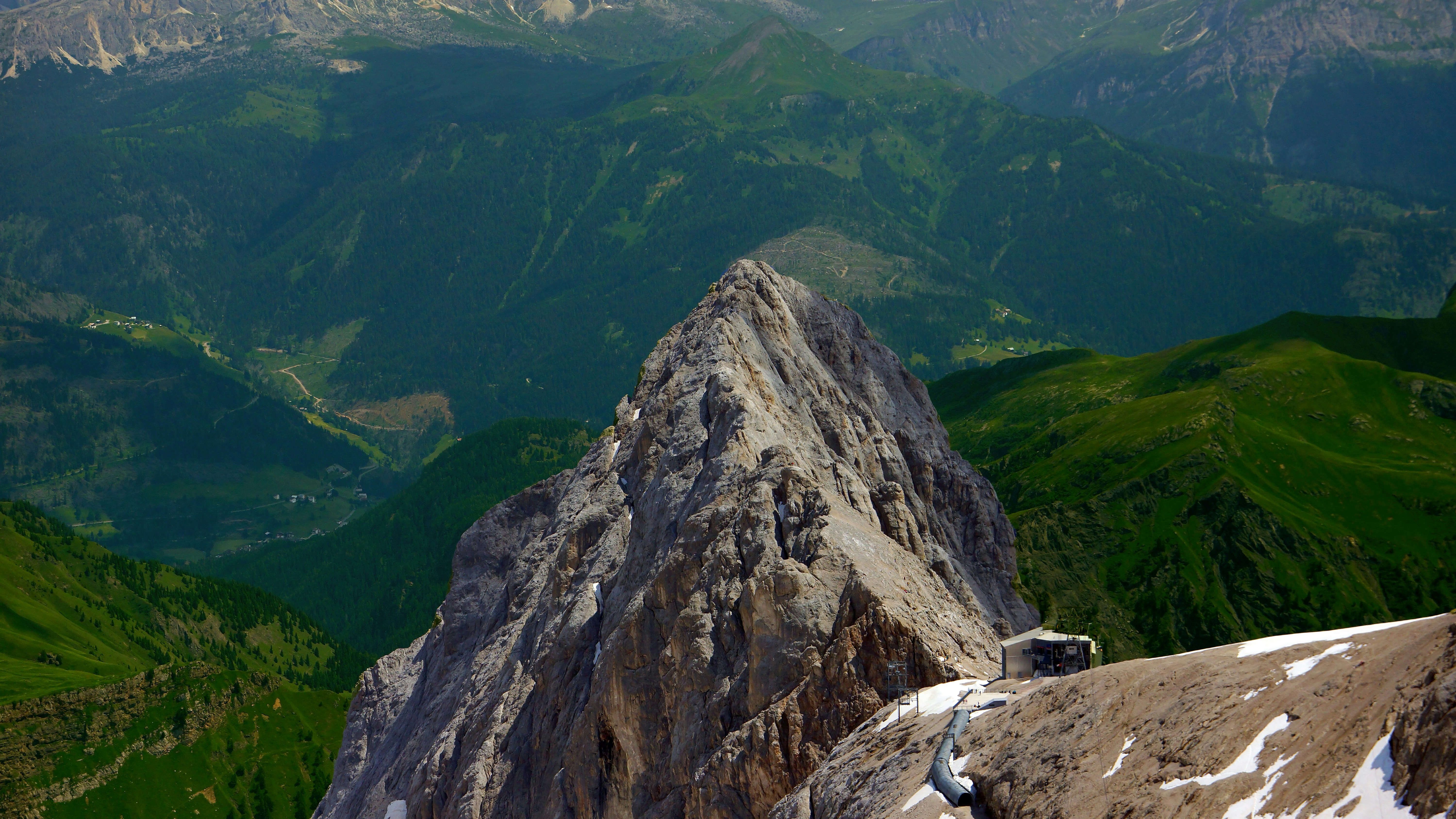 a man standing on top of a snow covered mountain