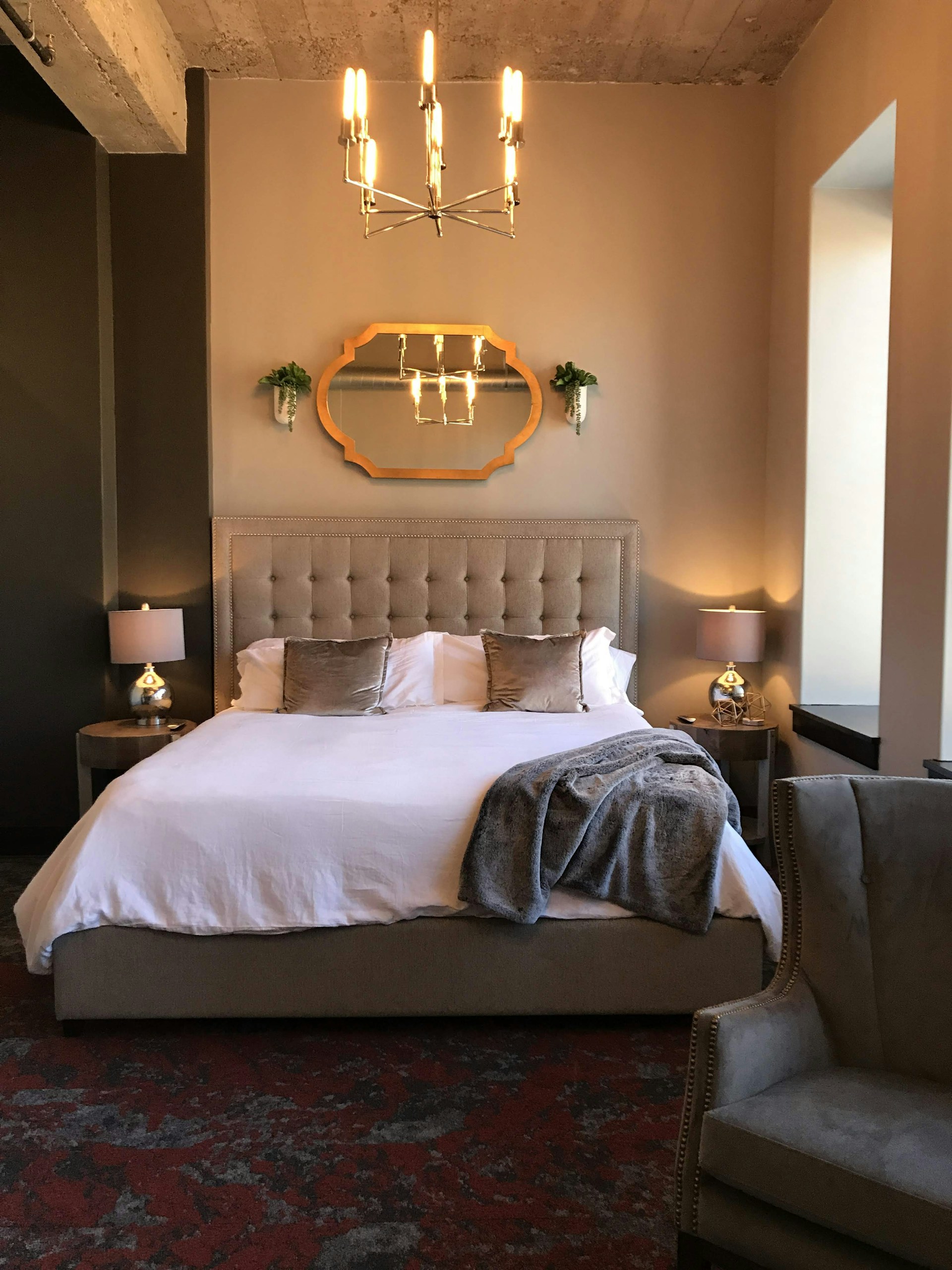 A modern bedroom showcasing a beautifully crafted bed with elegant bedding.