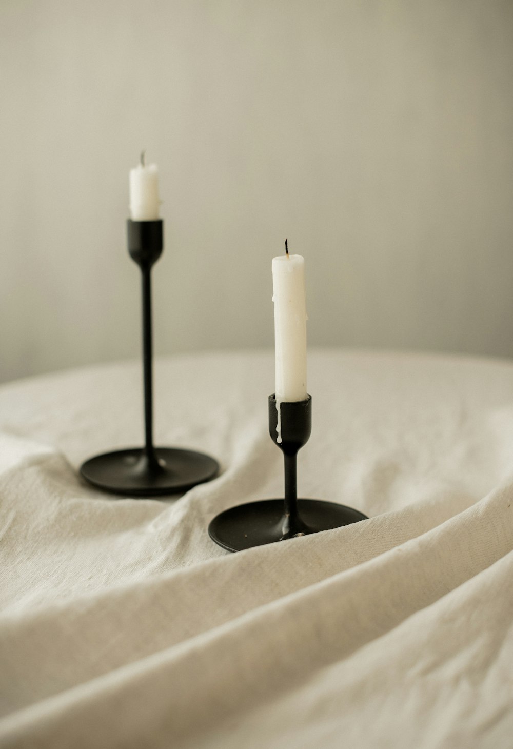 a couple of candles sitting on top of a bed