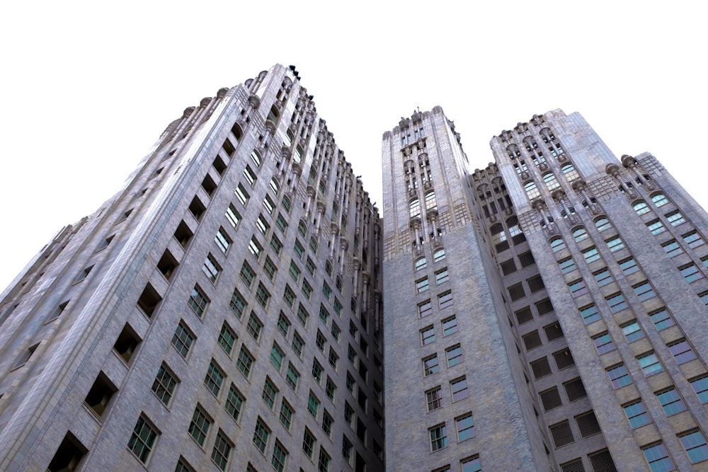two tall buildings with windows on each of them