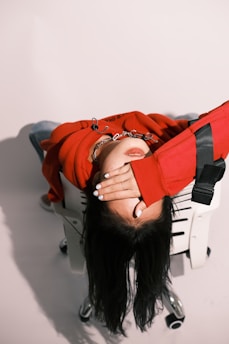 a woman laying on top of a white chair