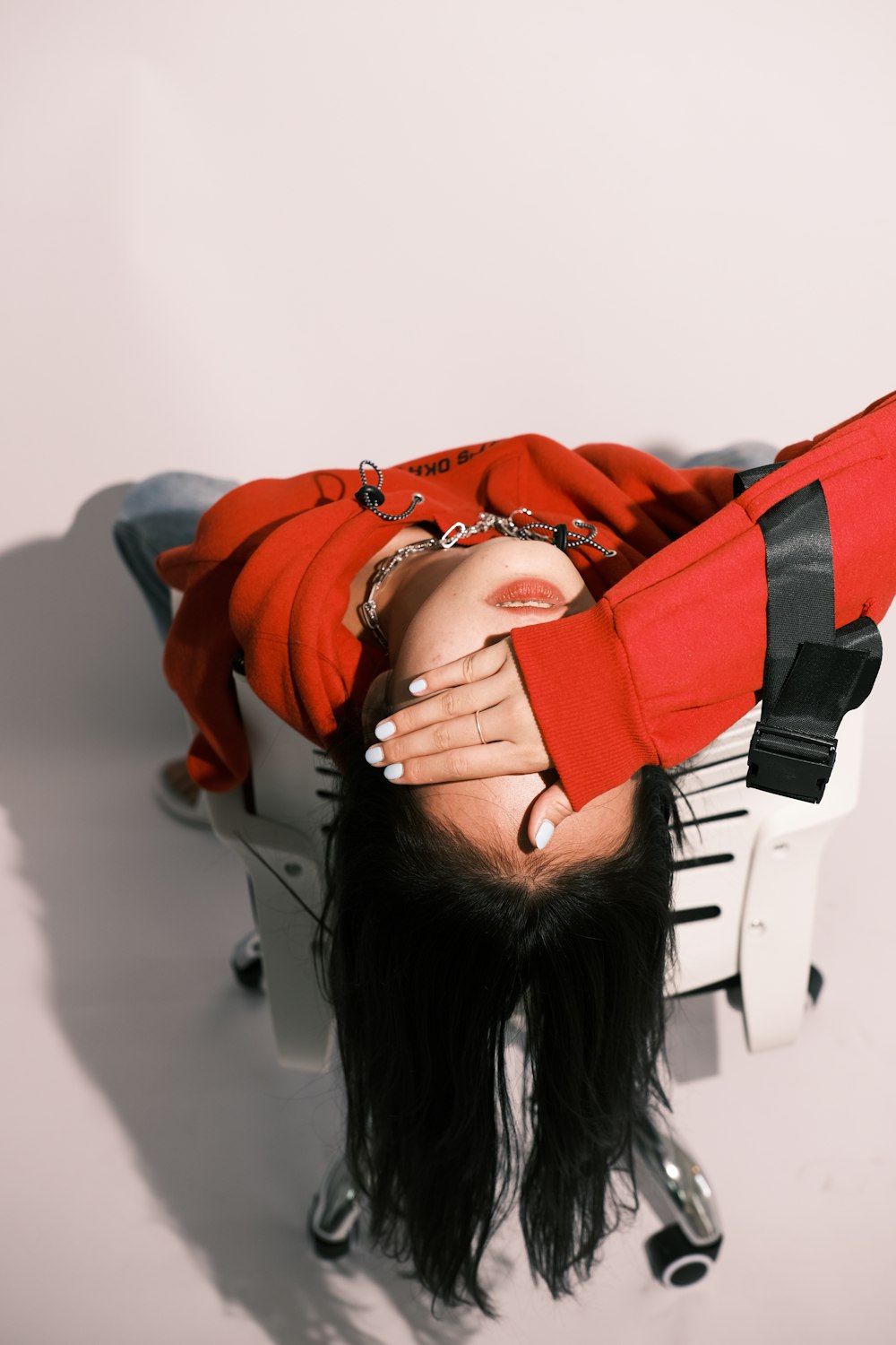 a woman laying on top of a white chair