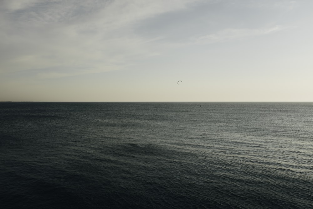 a large body of water under a cloudy sky