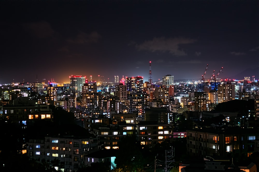 a view of a city at night from the top of a hill