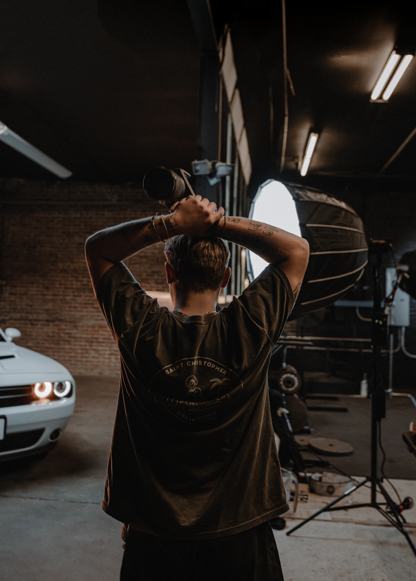 Cameraman filming on location in an automotive shop