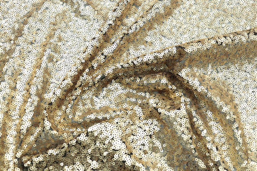 a close up of a gold sequin fabric