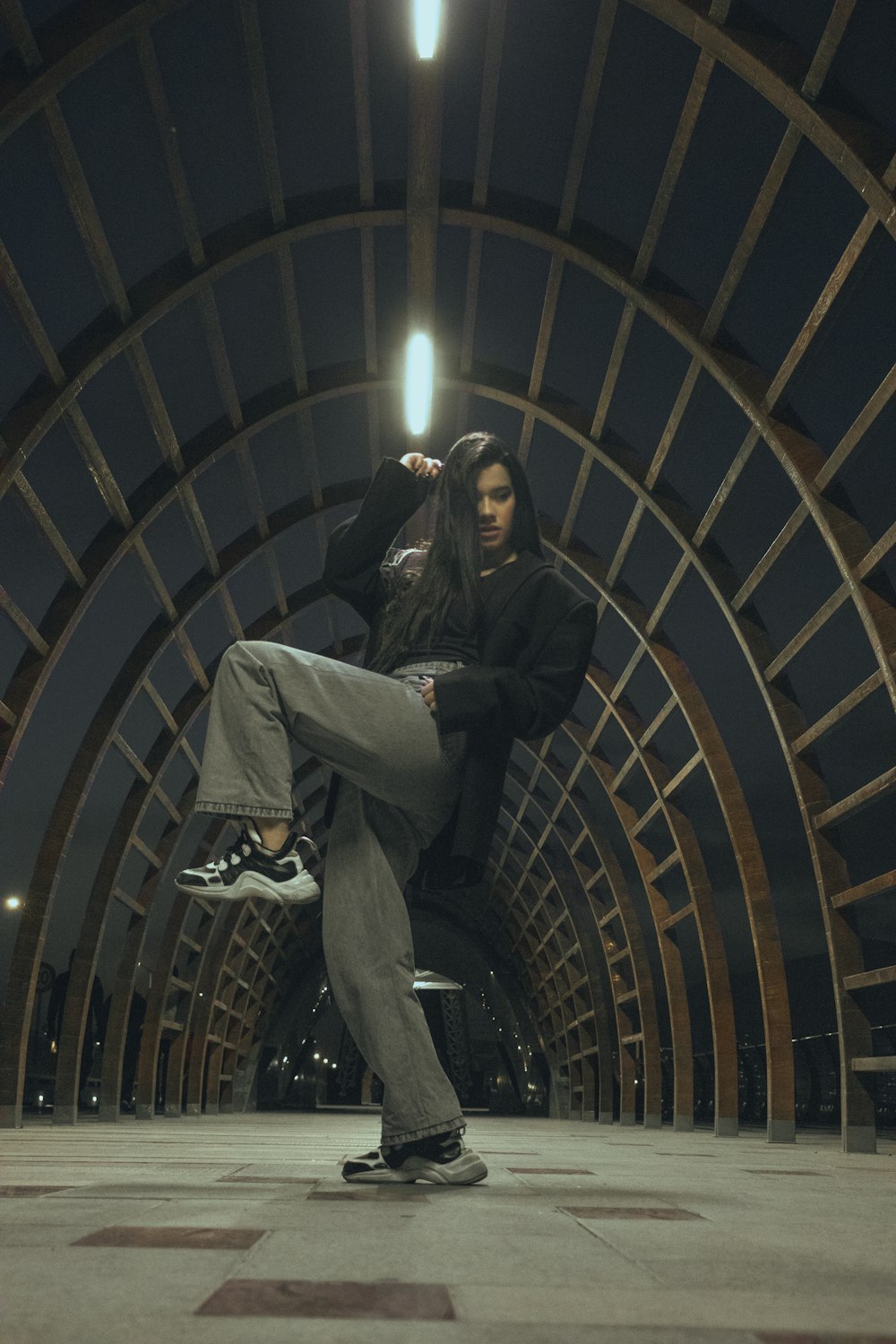 a man riding a skateboard through a tunnel