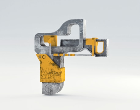 A modern, industrial-shaped structure made of metallic gray and yellow elements, featuring geometric forms and detailed textures.