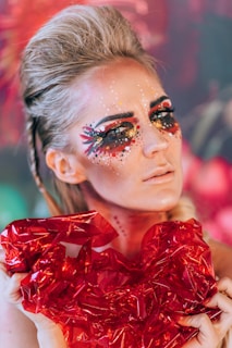 a woman with a red dress and makeup