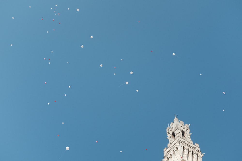 a group of balloons are flying in the sky