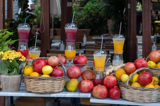 a table topped with baskets of fruit and drinks