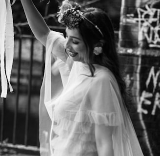 a woman in a white dress holding a bouquet of flowers