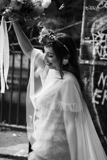 a woman in a white dress holding a bouquet of flowers