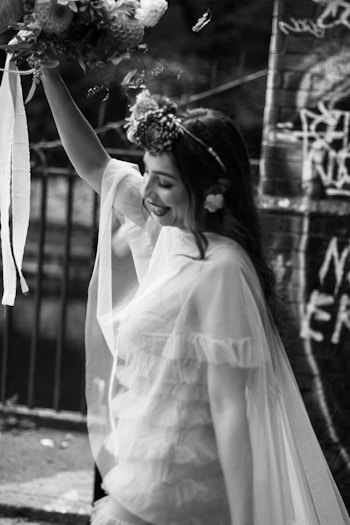 a woman in a white dress holding a bouquet of flowers