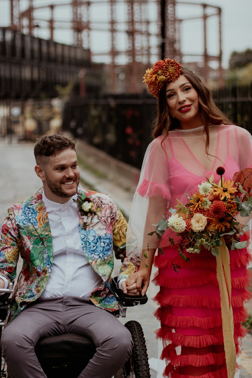 a man in a wheelchair and a woman in a dress